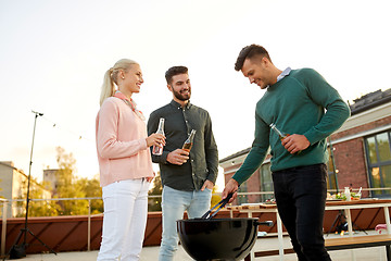 Image showing happy friends having bbq party on rooftop