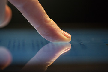 Image showing close up of hand using computer touch screen