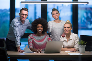 Image showing Multiethnic startup business team in night office