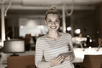 Image showing woman working on digital tablet in night office