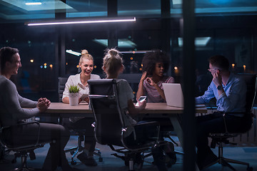 Image showing Multiethnic startup business team in night office