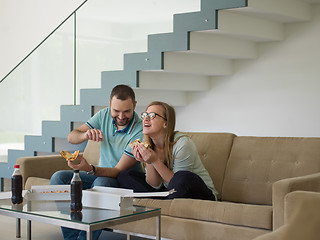 Image showing couple eating pizza in their luxury home villa