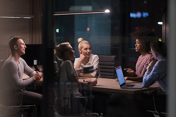 Image showing Multiethnic startup business team in night office