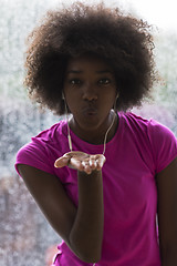 Image showing portrait of young afro american woman in gym while listening mus