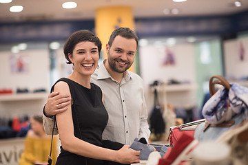 Image showing couple chooses shoes At Shoe Store