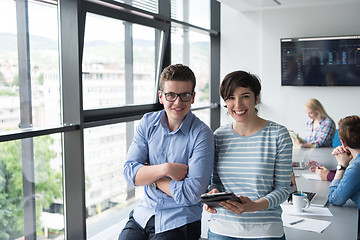 Image showing Two Business People Working With Tablet in office