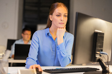 Image showing businesswoman at computer working at night office