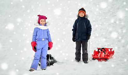 Image showing happy little kids with sleds in winter