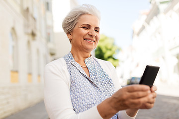 Image showing happy senior woman with smartphone in summer