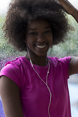 Image showing portrait of young afro american woman in gym while listening mus