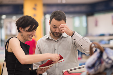 Image showing couple chooses shoes At Shoe Store