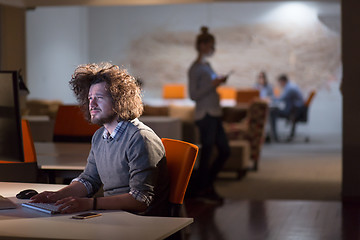 Image showing man working on computer in dark office