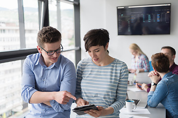 Image showing Two Business People Working With Tablet in office