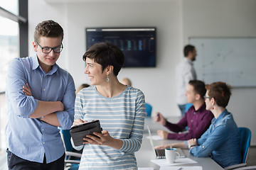 Image showing Two Business People Working With Tablet in office