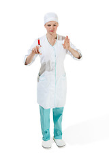 Image showing beautiful young woman doctor in medical robe holding syringe in hand.