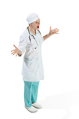 Image showing Beautiful young woman is surprised in white coat posing at studio. Full length studio shot isolated on white.