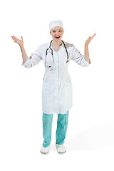 Image showing Beautiful young woman in white coat posing and laughs at studio. Full length studio shot isolated on white.