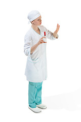 Image showing beautiful young woman doctor in medical robe holding syringe in hand.