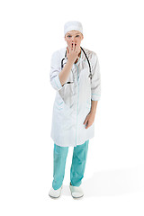 Image showing Beautiful young woman is shoked in white coat posing at studio. Full length studio shot isolated on white.