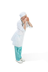 Image showing Beautiful young woman in white coat posing at studio. Full length studio shot isolated on white.