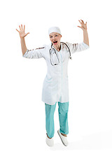 Image showing Beautiful young woman in white coat posing at studio. Full length studio shot isolated on white.