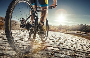 Image showing Detail of cyclist man feet riding mountain bike on outdoor trail on country road