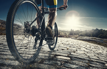 Image showing Detail of cyclist man feet riding mountain bike on outdoor trail on country road