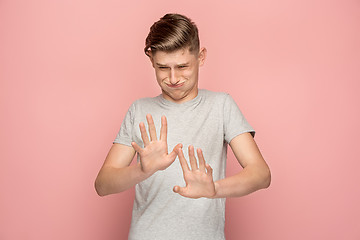 Image showing Let me think. Doubtful pensive man with thoughtful expression making choice against pink background