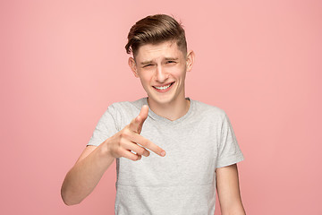 Image showing The happy business man point you and want you, half length closeup portrait on pink background.