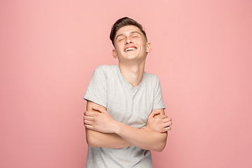 Image showing The happy businessman standing and smiling against pink background.