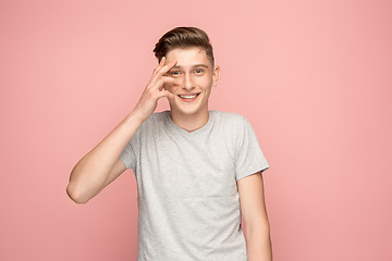 Image showing Handsome man looking suprised isolated on pink