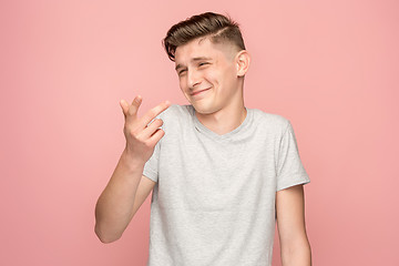 Image showing The happy business man standing and smiling against pink background.