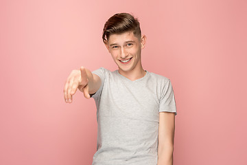 Image showing The happy business man point you and want you, half length closeup portrait on pink background.