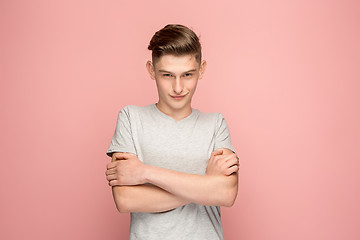 Image showing The serious businessman standing and looking at camera against pink background.