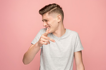 Image showing The happy business man point you and want you, half length closeup portrait on pink background.