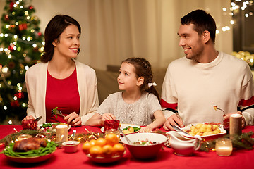 Image showing happy family having christmas dinner at home