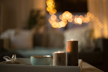 Image showing close up of candles, christmas gift and mug