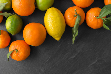 Image showing close up of citrus fruits on stone table