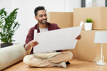 Image showing man with boxes and blueprint moving to new home