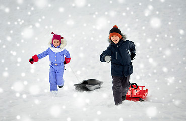 Image showing happy kids with sled having fun outdoors in winter