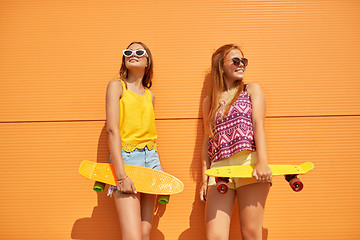 Image showing teenage girls with short skateboards in city