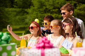 Image showing happy kids taking selfie on birthday party