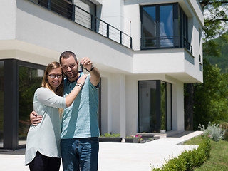 Image showing couple hugging in front of  new luxury home