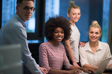 Image showing Multiethnic startup business team in night office