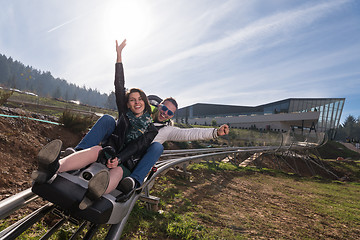 Image showing couple enjoys driving on alpine coaster