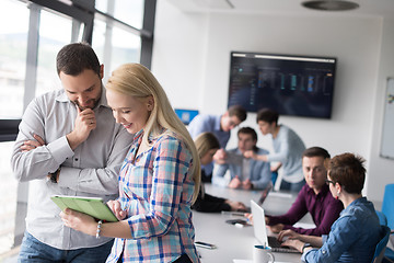 Image showing Two Business People Working With Tablet in office