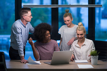 Image showing Multiethnic startup business team in night office