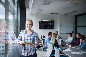 Image showing Pretty Businesswoman Using Tablet In Office Building by window