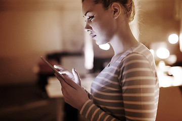 Image showing woman working on digital tablet in night office