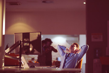 Image showing businessman relaxing at the desk